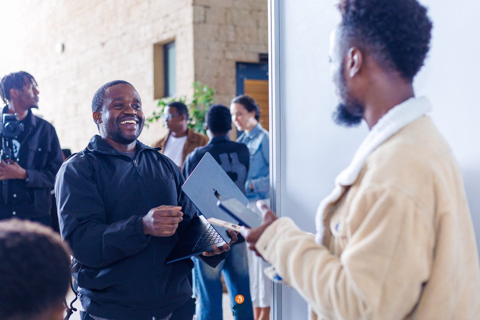 Two attendees in conversation at a Bitcoin community event in Kenya